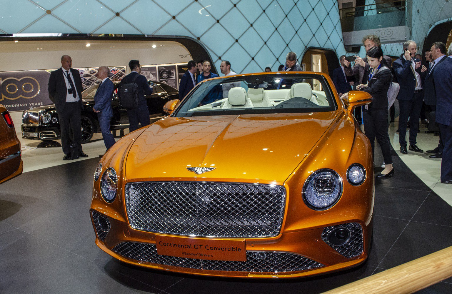 Front view of orange convertible with diamond grille and round headlights