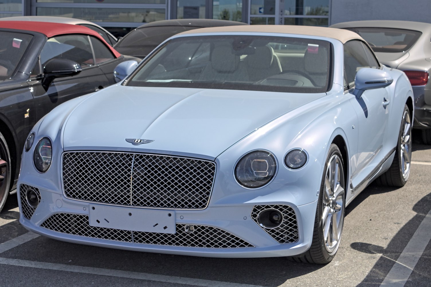 Convertible luxury car with distinctive front grille and LED headlights