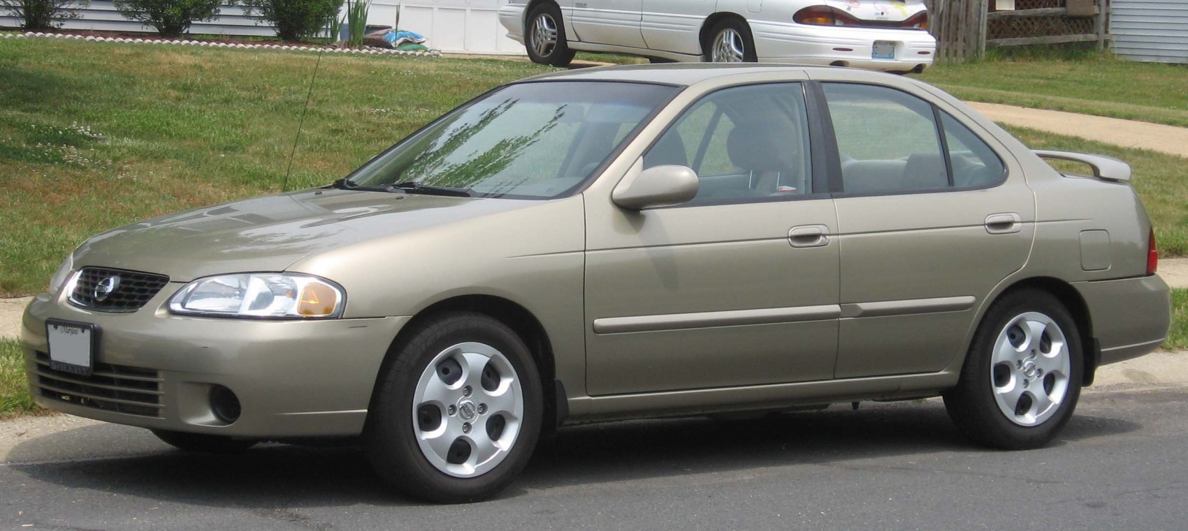 Sedan with alloy wheels and rear spoiler parked on street