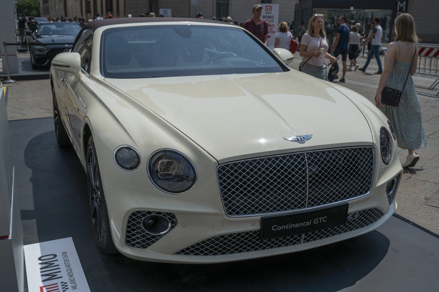 Luxury convertible with diamond-pattern grille and round headlights.
