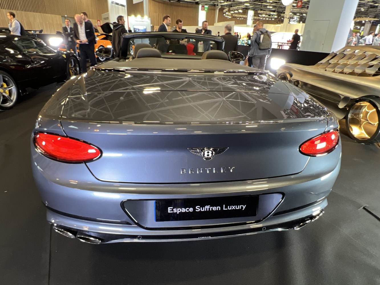 Rear view of luxury convertible with distinctive taillights and dual exhausts