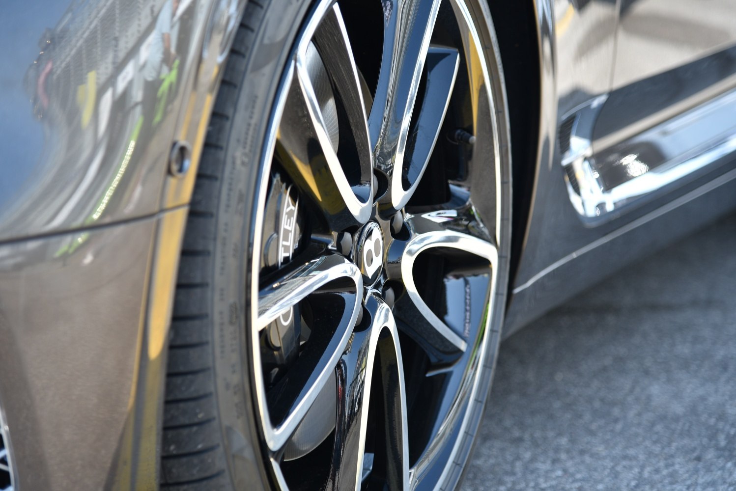 Close-up of a polished black and silver alloy wheel with Bentley branding