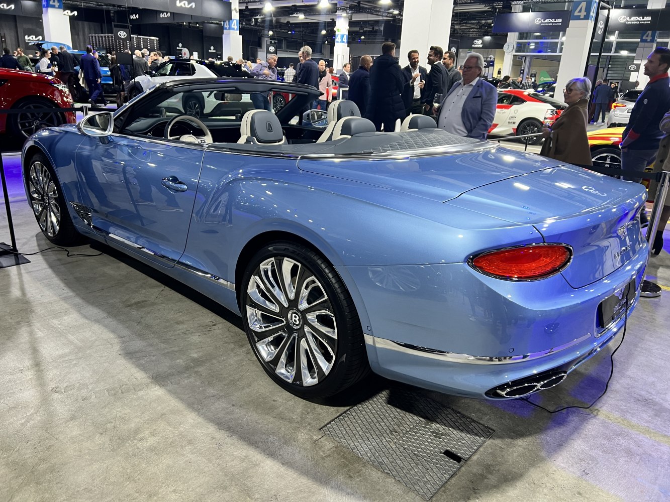 Luxury convertible with distinct rear lights, chrome accents, and multi-spoke wheels