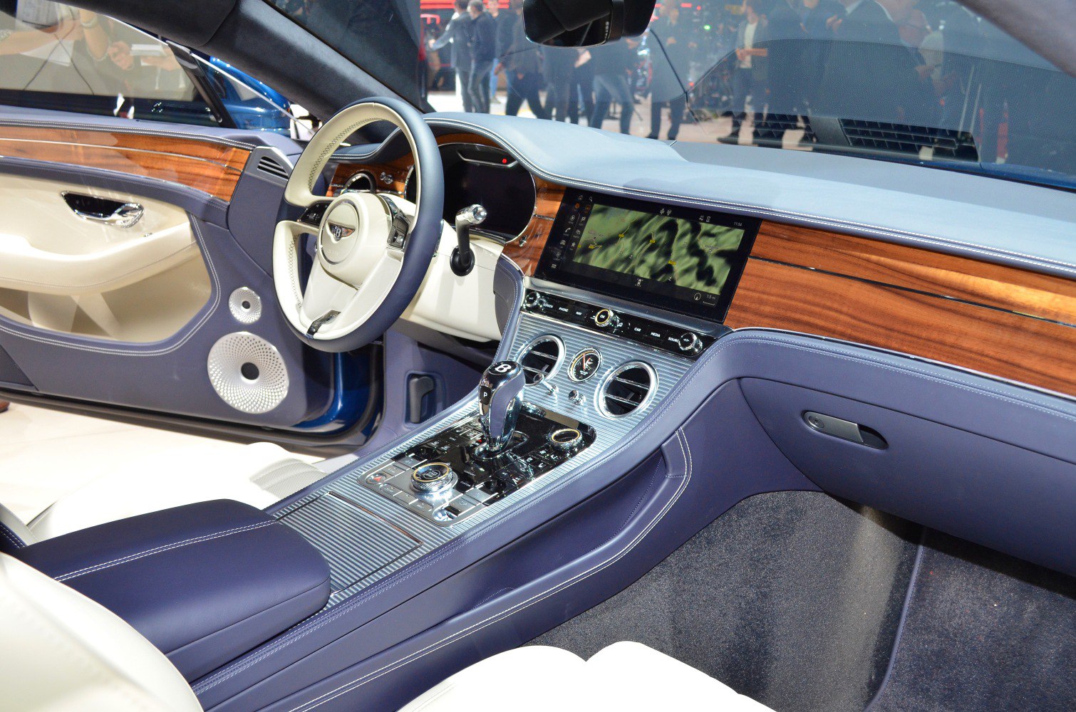 Luxury car interior with wood trim, infotainment screen, and premium center console design