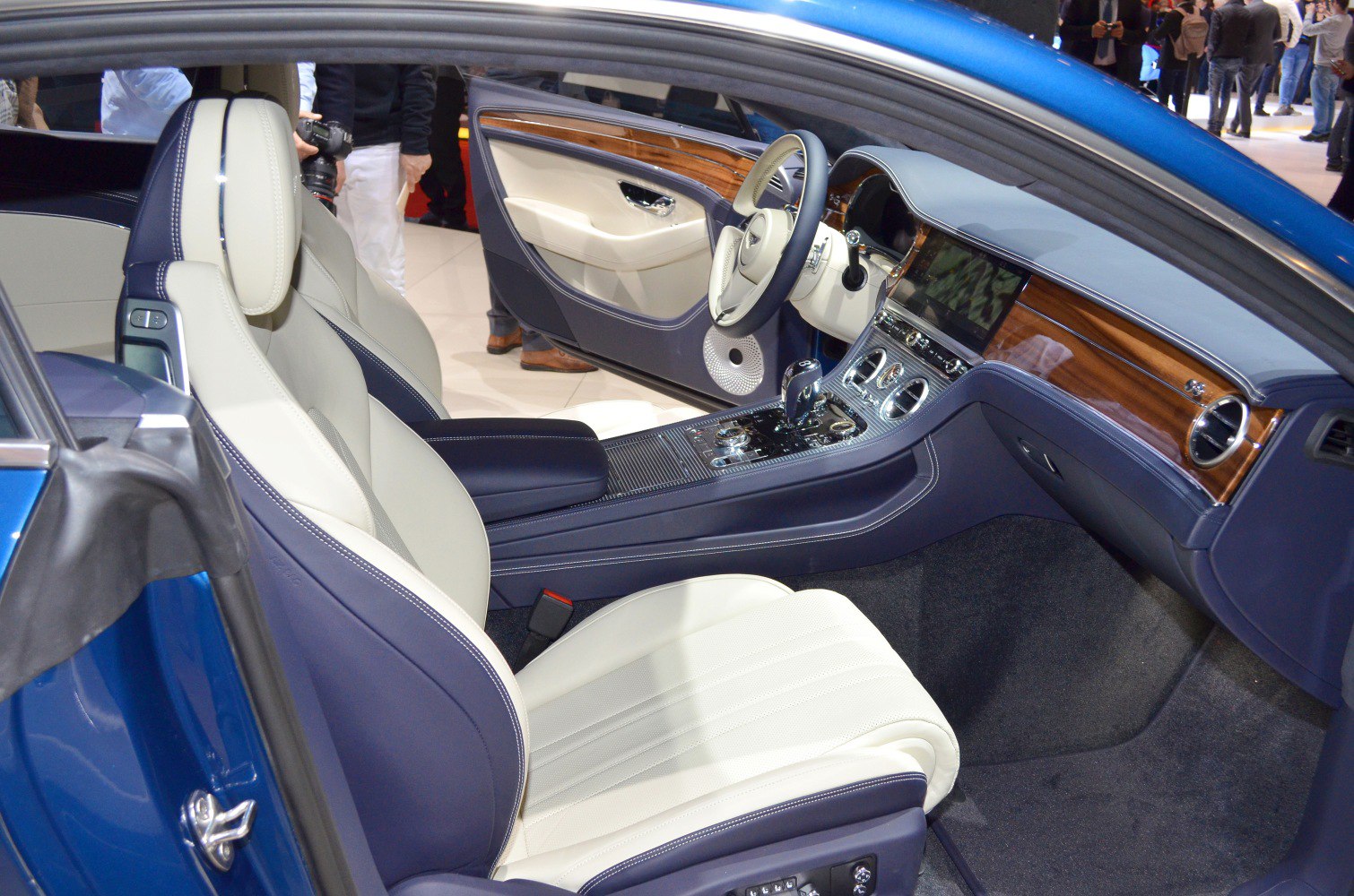 Luxury car interior with dual-tone leather seats and wood trim