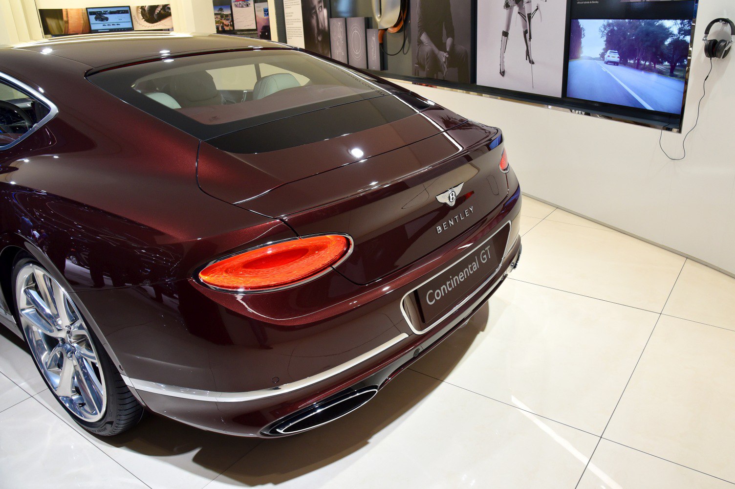 Luxury coupe rear with distinctive taillights, chrome trim, and dual exhausts