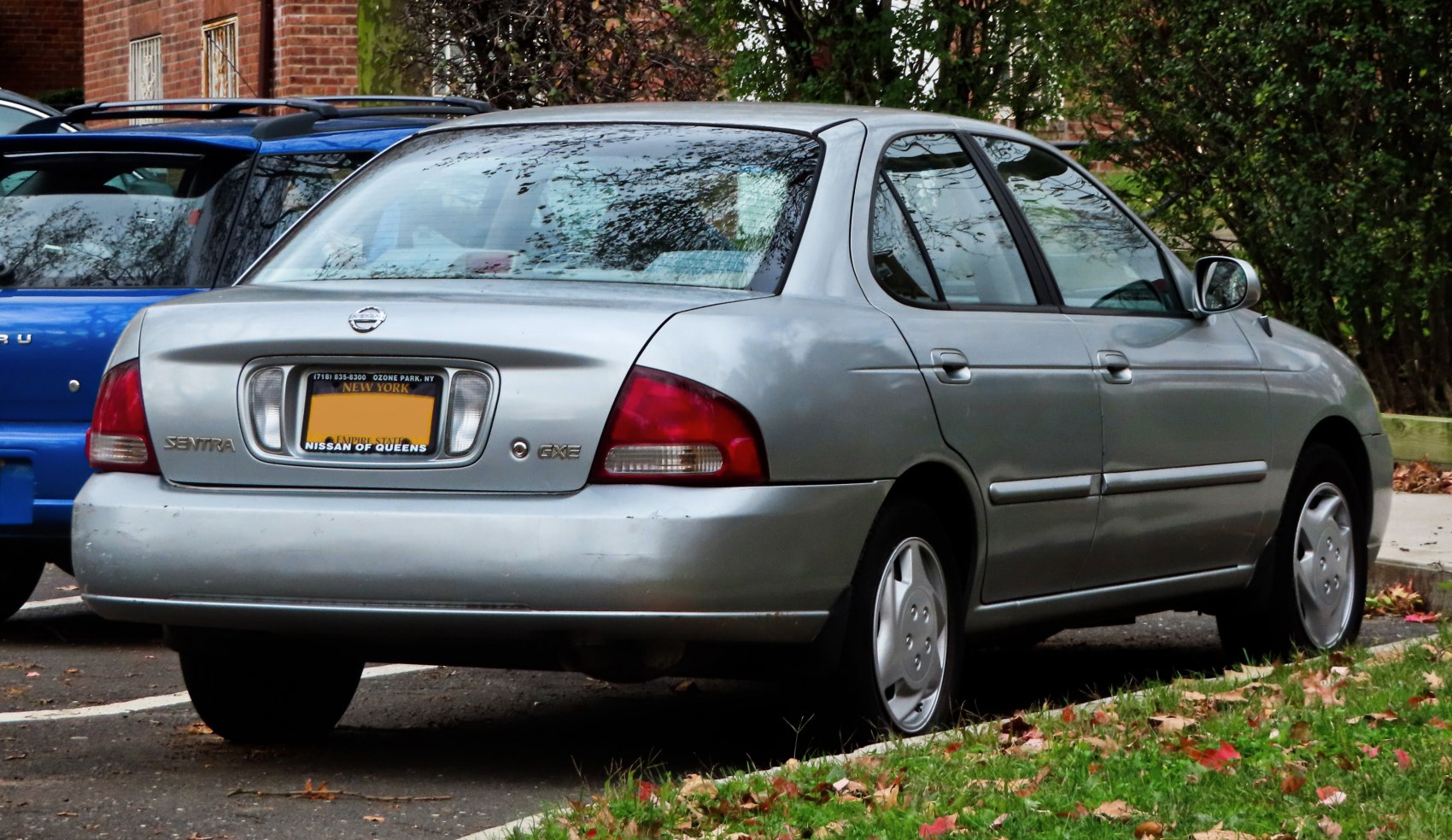 Silver sedan rear view with distinct taillights and license plate frame