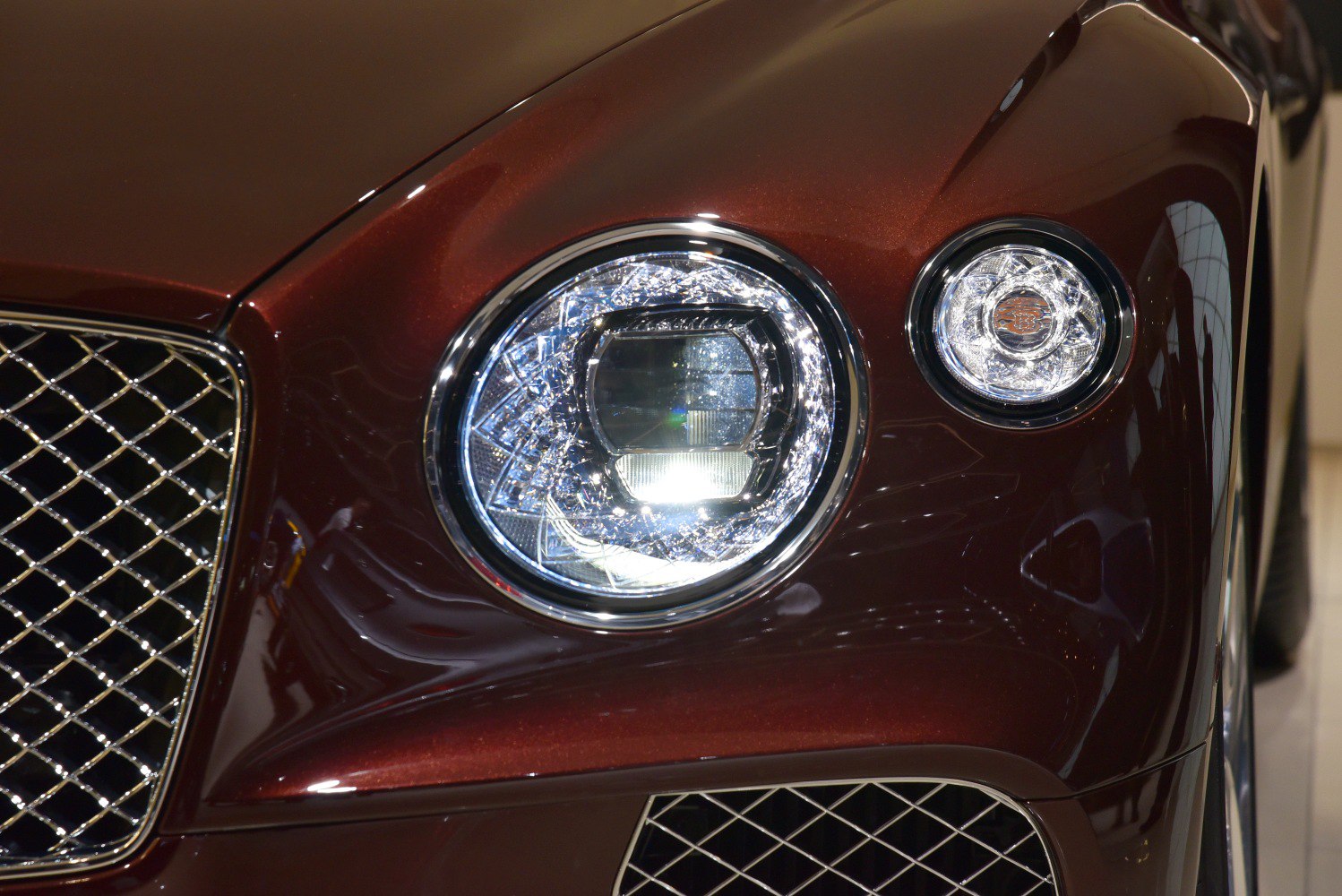 Round headlights with intricate crystal design and mesh front grille