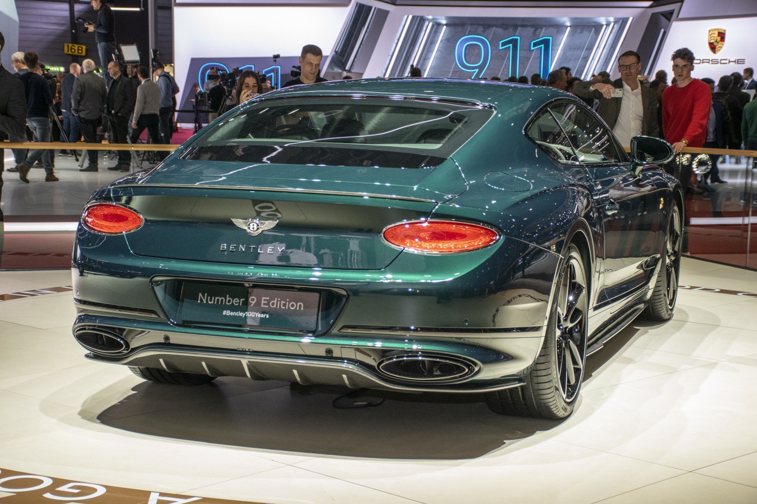 Rear view of luxury coupe with oval LED taillights and large dual exhausts