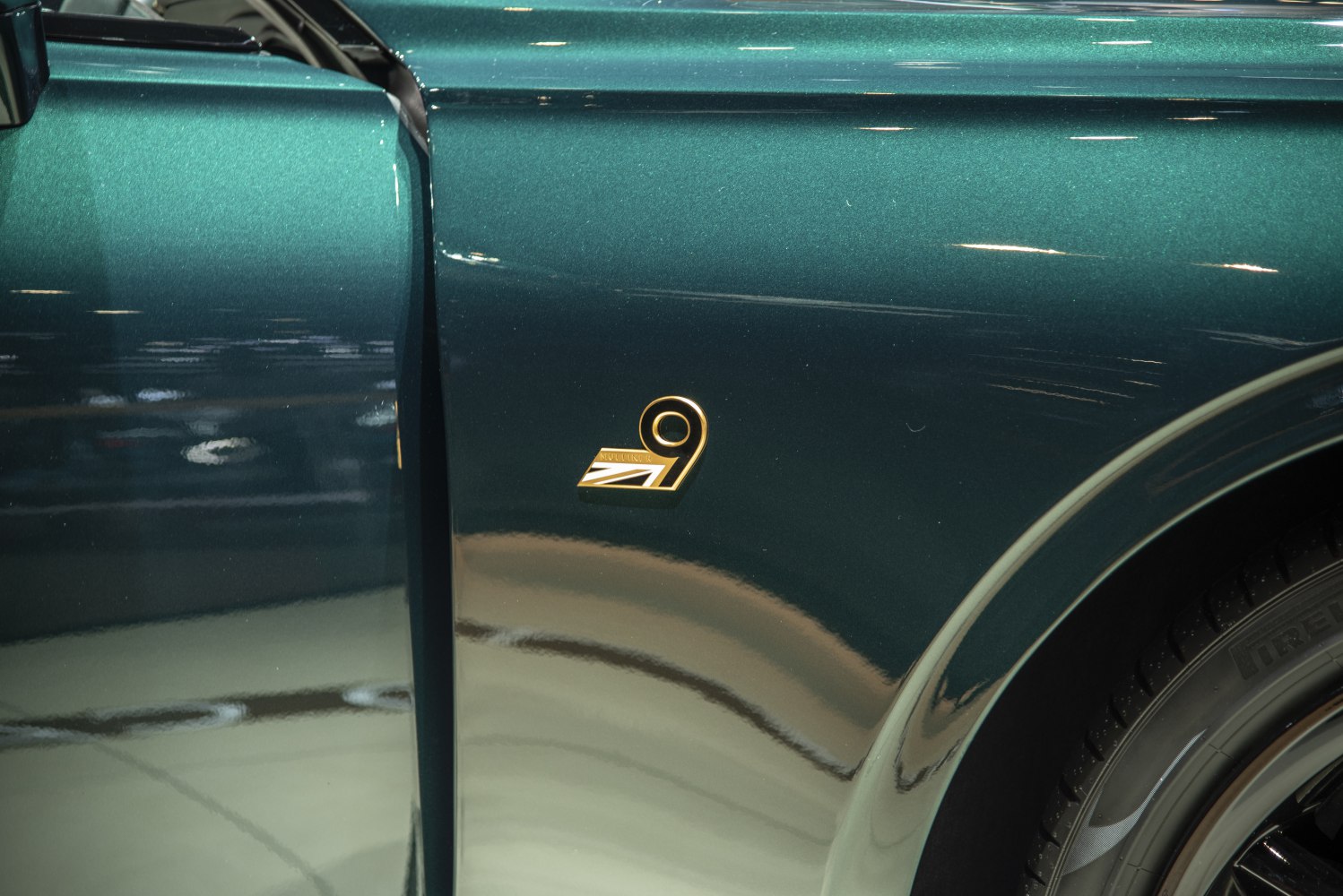 Side badge and rear wheel with tire close-up in dark green finish