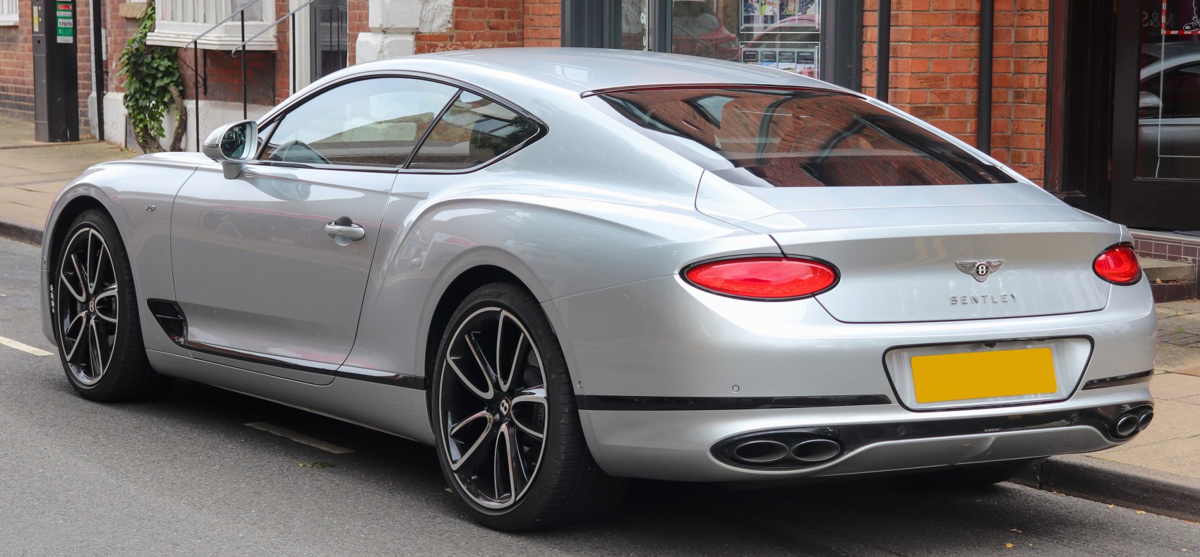 Silver luxury coupe rear with distinctive taillights and quad exhausts