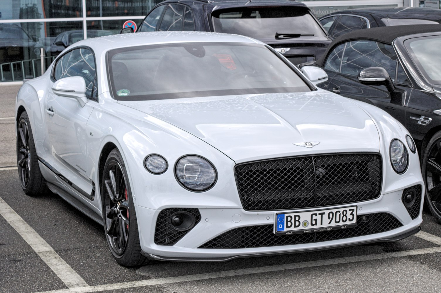 Luxury coupe with round headlights and black mesh grille