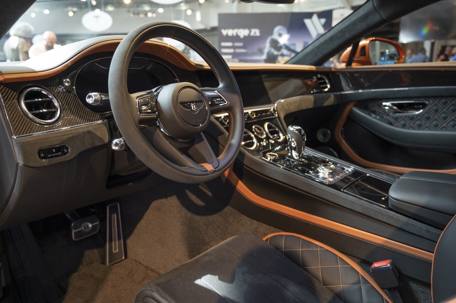 Luxury steering wheel and detailed dashboard with quilted leather and carbon fiber trim