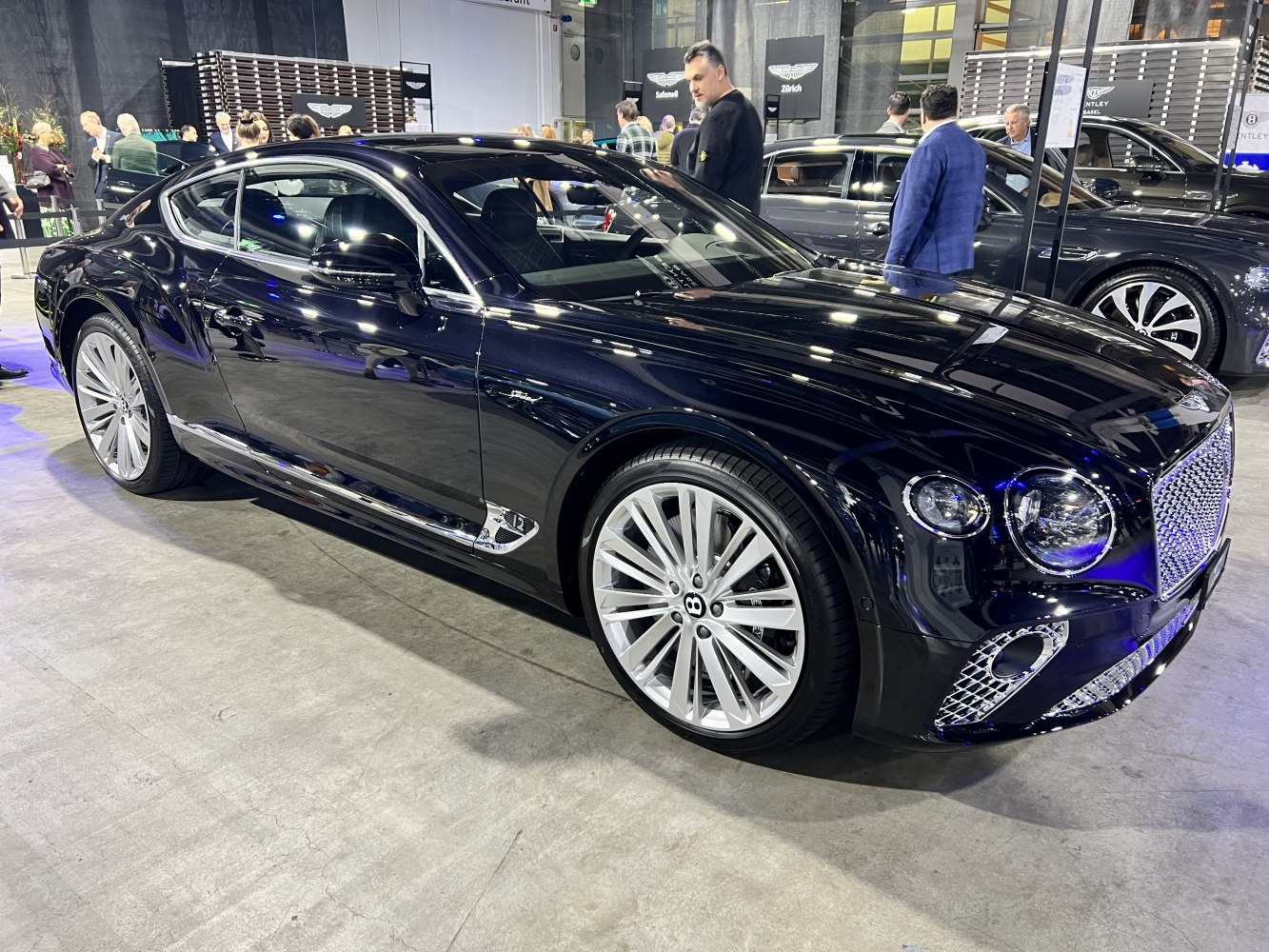Black luxury coupe with Bentley signature grille and large alloy wheels