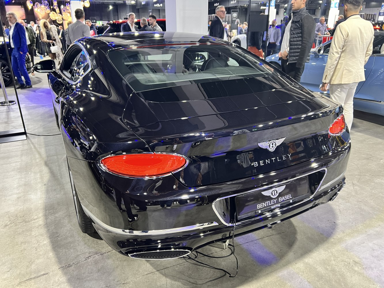 Rear view with oval tail lights and dual exhaust of a luxury coupe