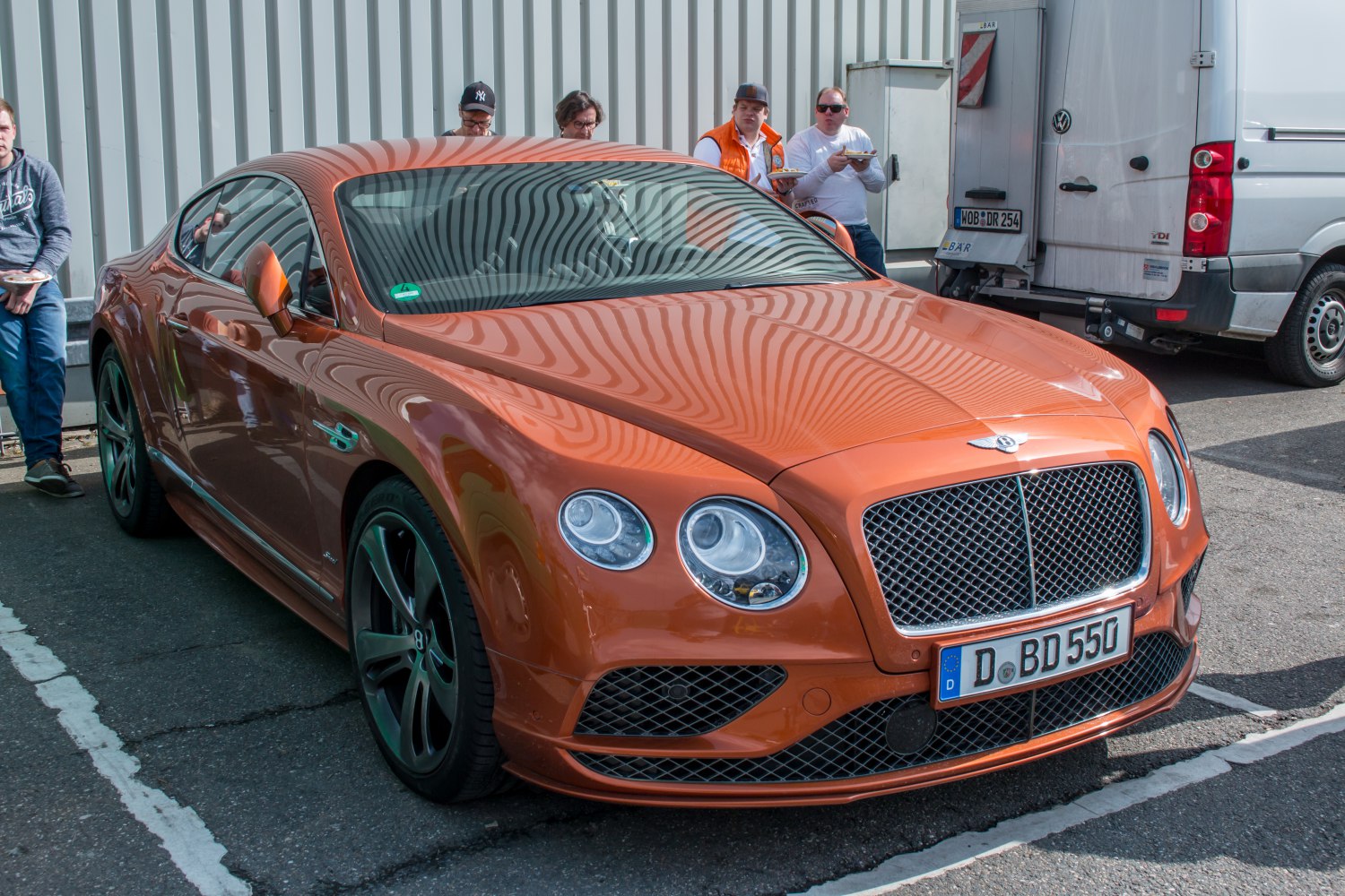 Front and side view with round headlights and mesh grille
