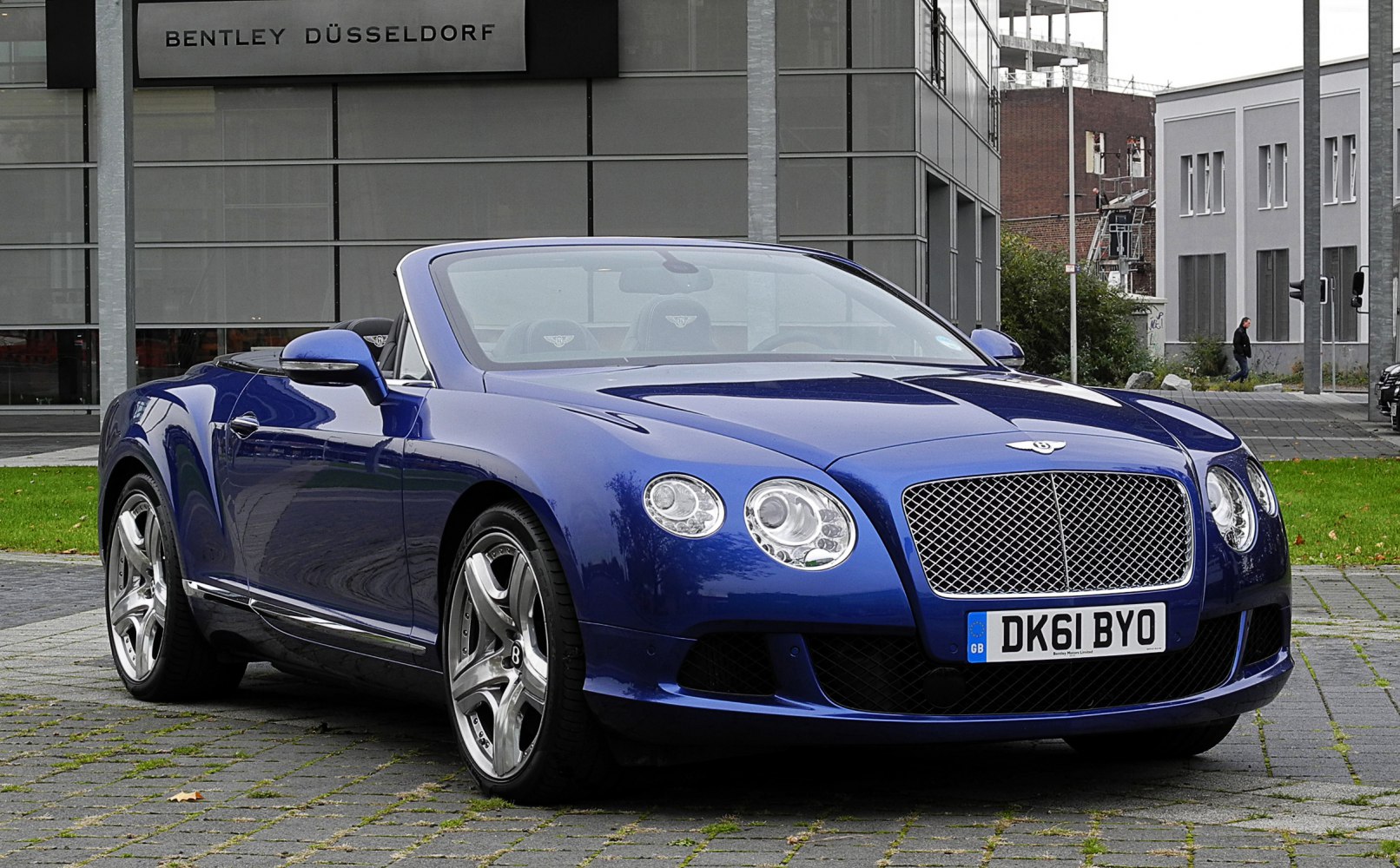 Blue luxury convertible with distinctive grille and round headlights