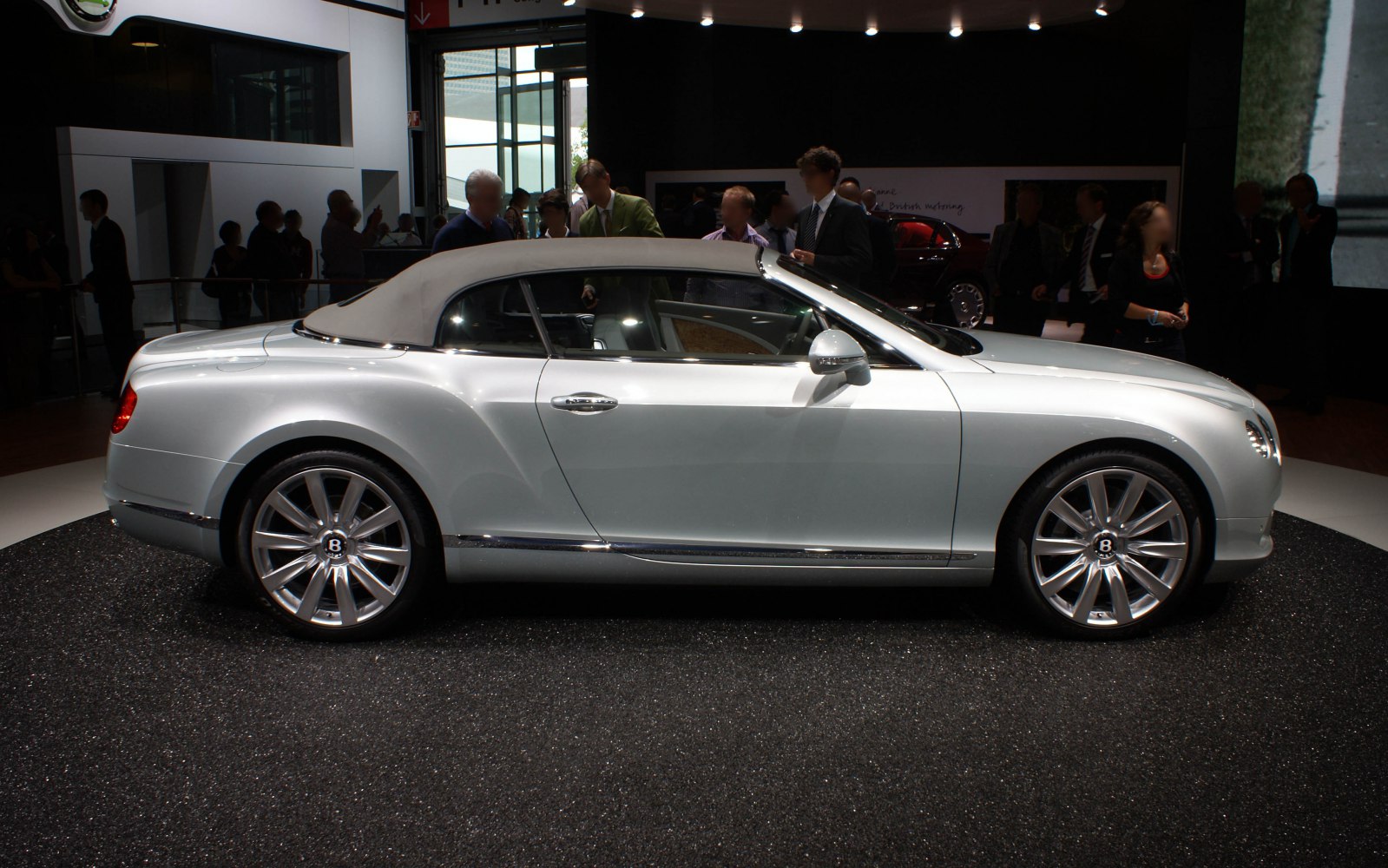 Side view of a luxury convertible with soft top roof and chrome trim