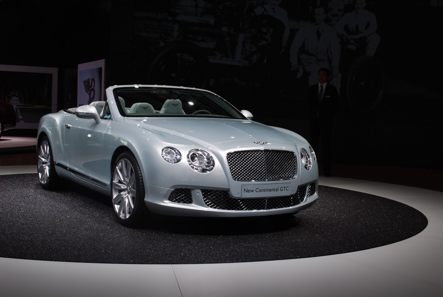 Convertible luxury vehicle with prominent front grille and round headlights