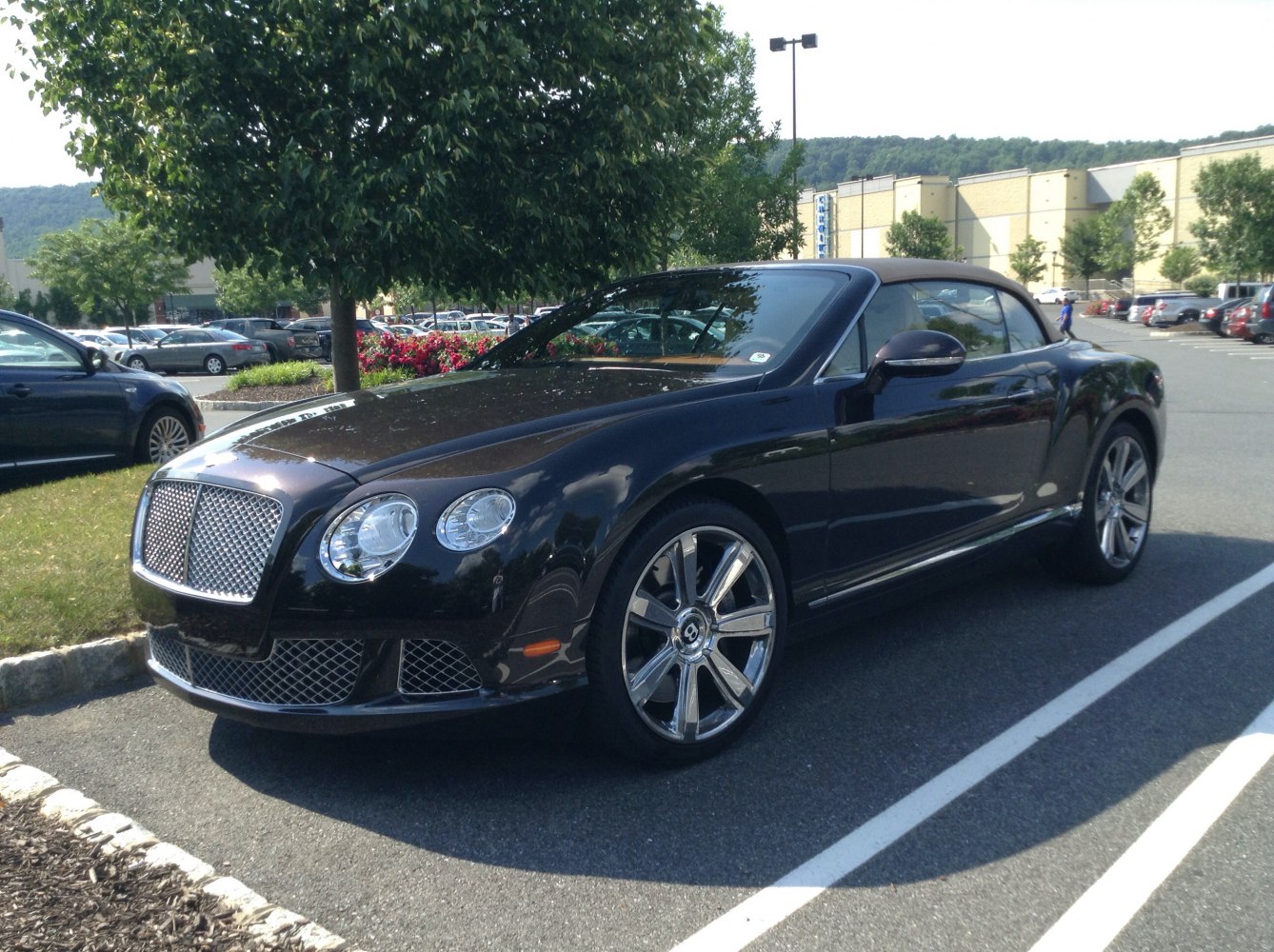 Luxury convertible with distinctive chrome grille and dual round headlights