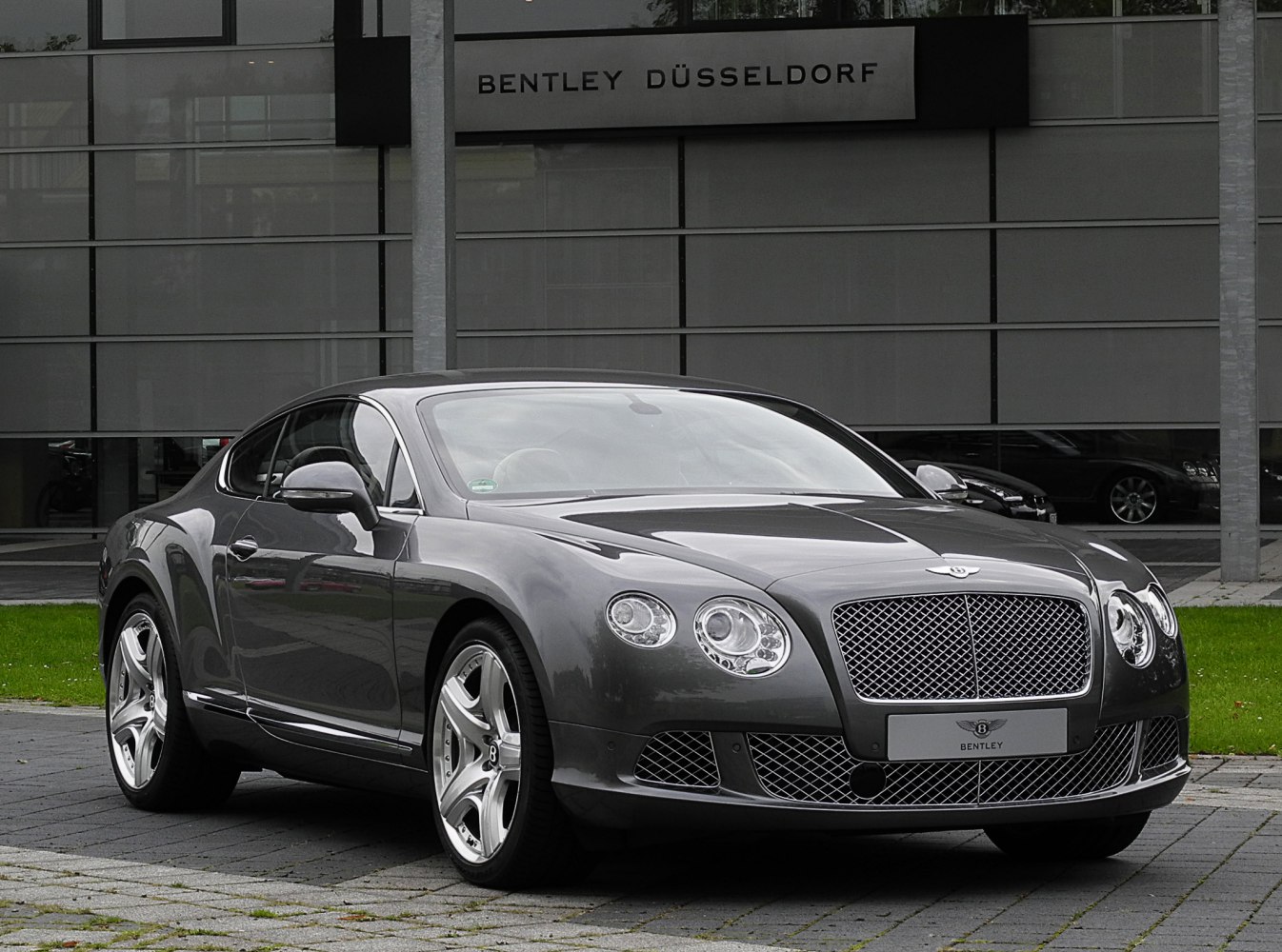 Front view of a luxury coupe with mesh grille and circular headlights
