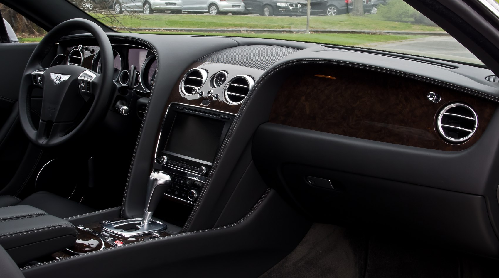 Luxury car interior with wood trim and touchscreen