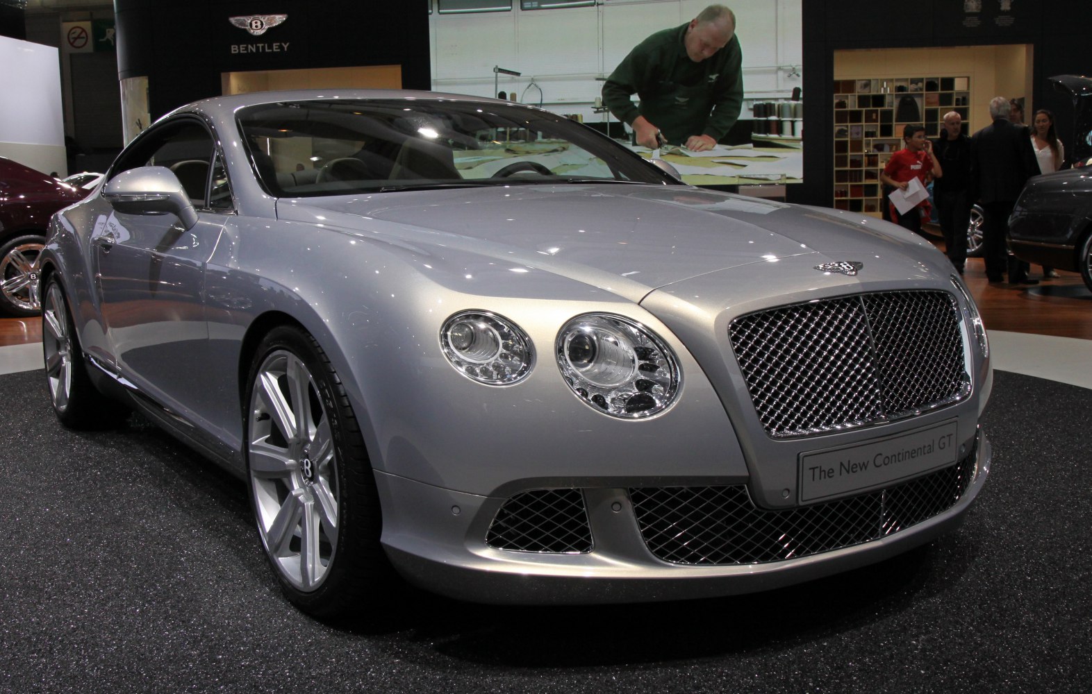 Dual round headlights and large mesh grille on luxury coupe