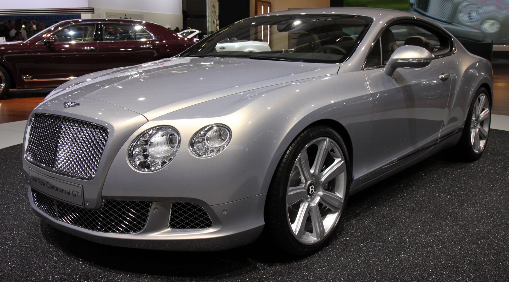 Luxury coupe front with large mesh grille and dual round headlights