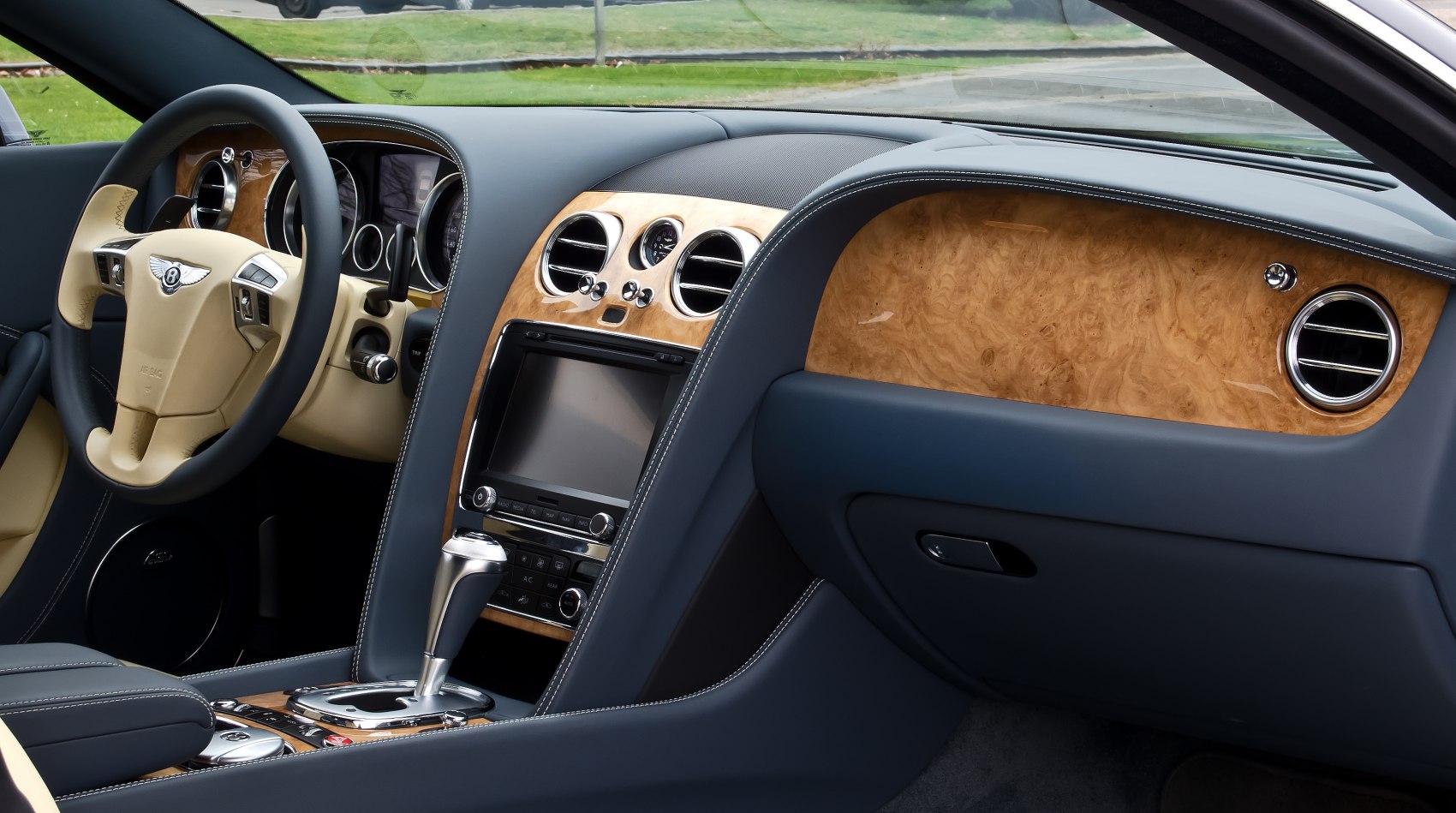 Luxury wood trim dashboard and steering wheel with premium leather seating
