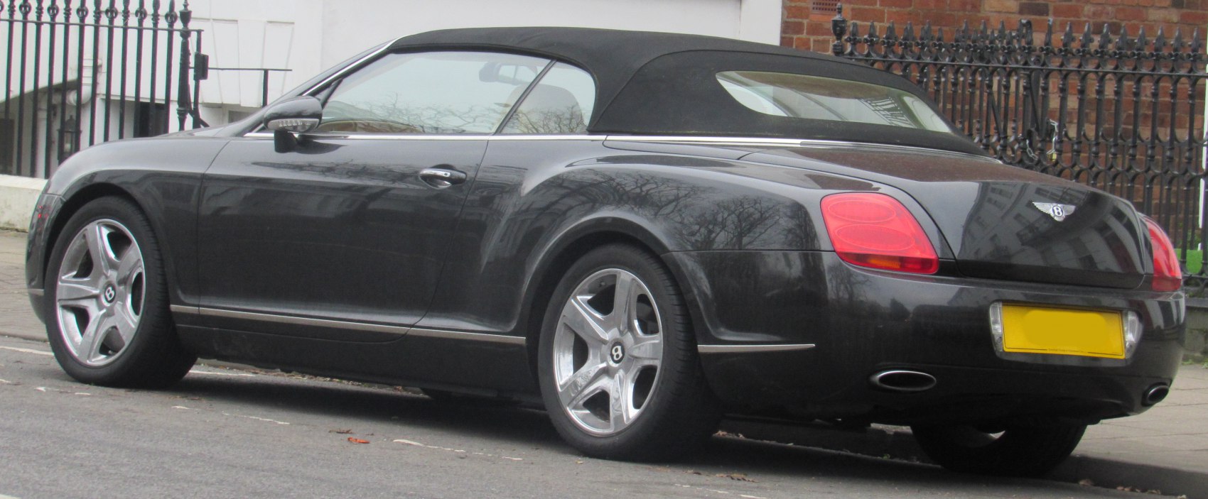 Convertible with black soft top and distinctive tail light design