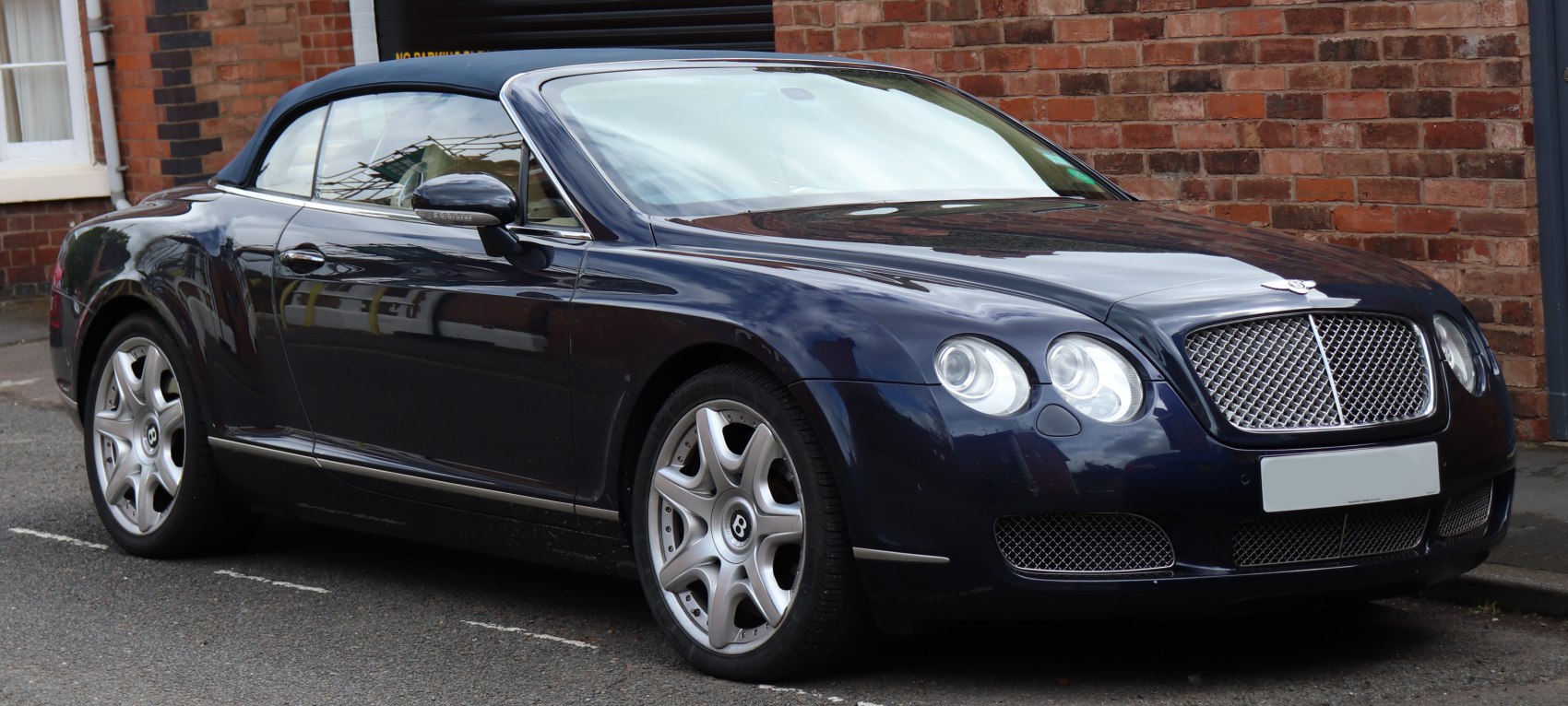 Luxury convertible with chrome mesh grille and dual round headlights