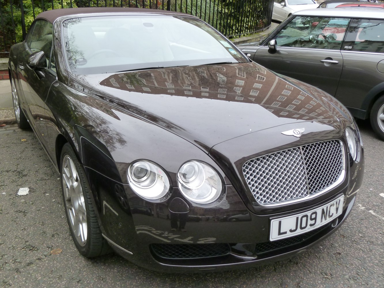 Luxury convertible with dual rounded headlights and mesh grille