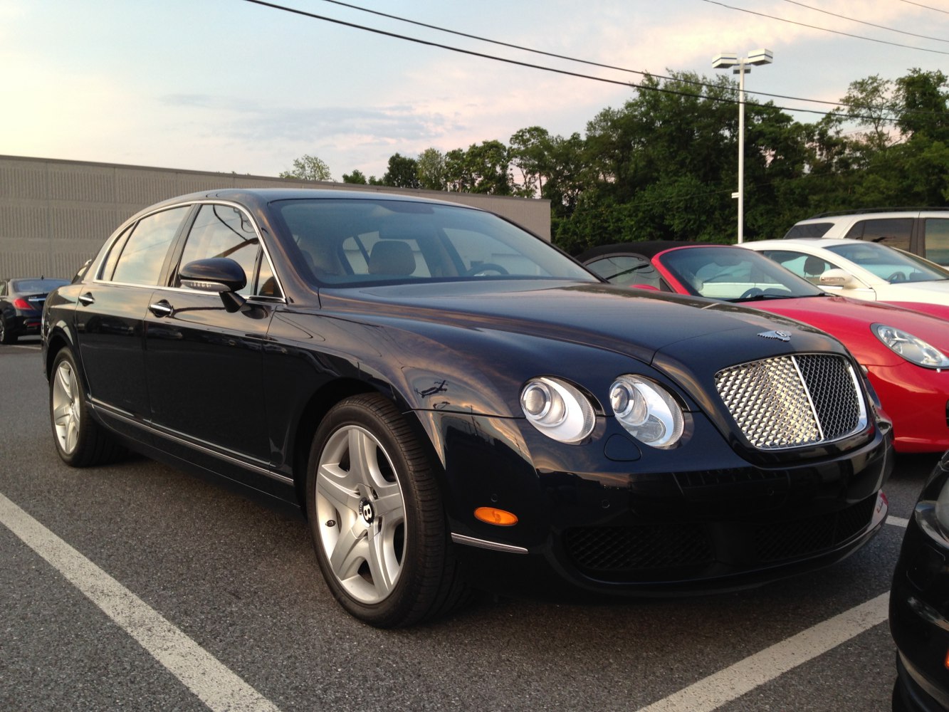 Luxury sedan with distinctive quad round headlights and large mesh grille.