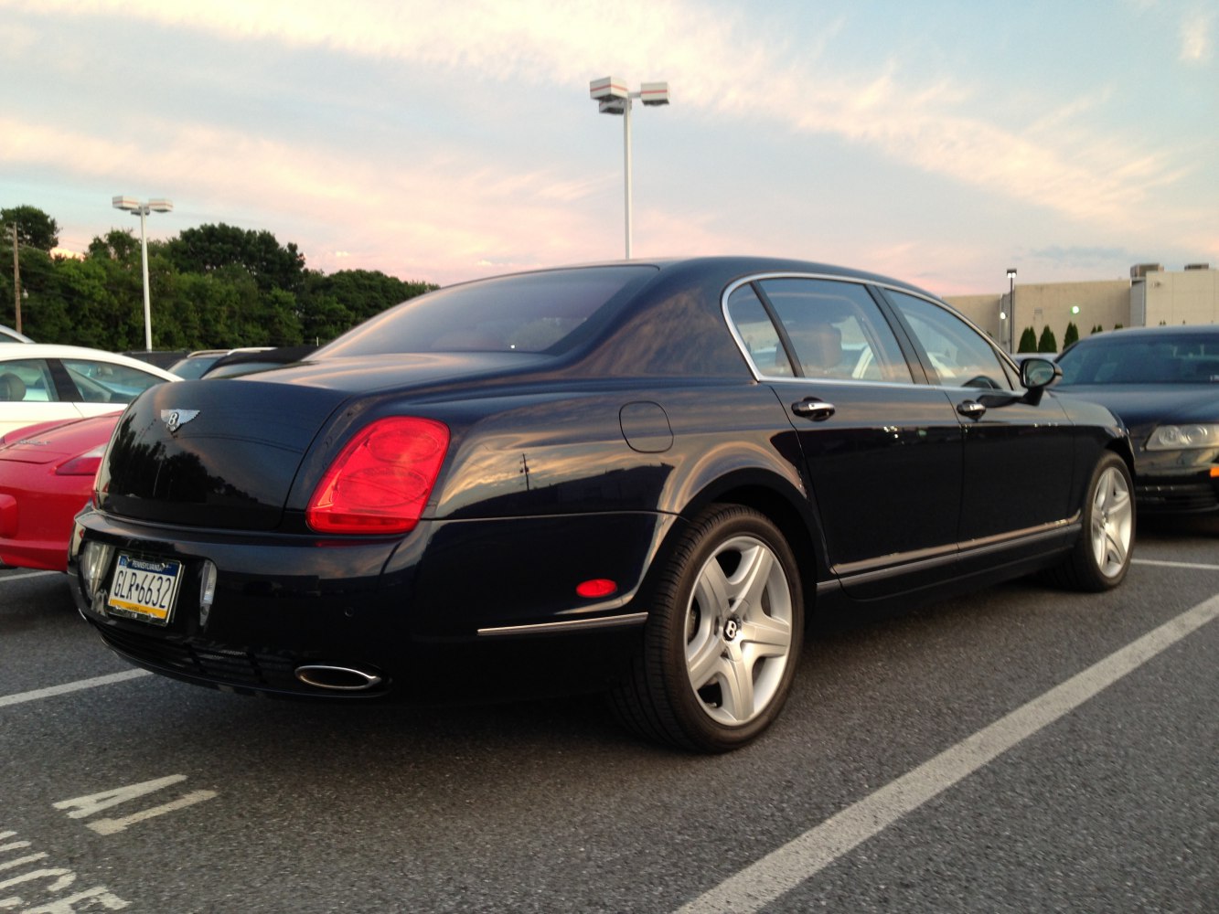 Rear side view of luxury sedan with distinctive tail lights and dual exhaust pipes