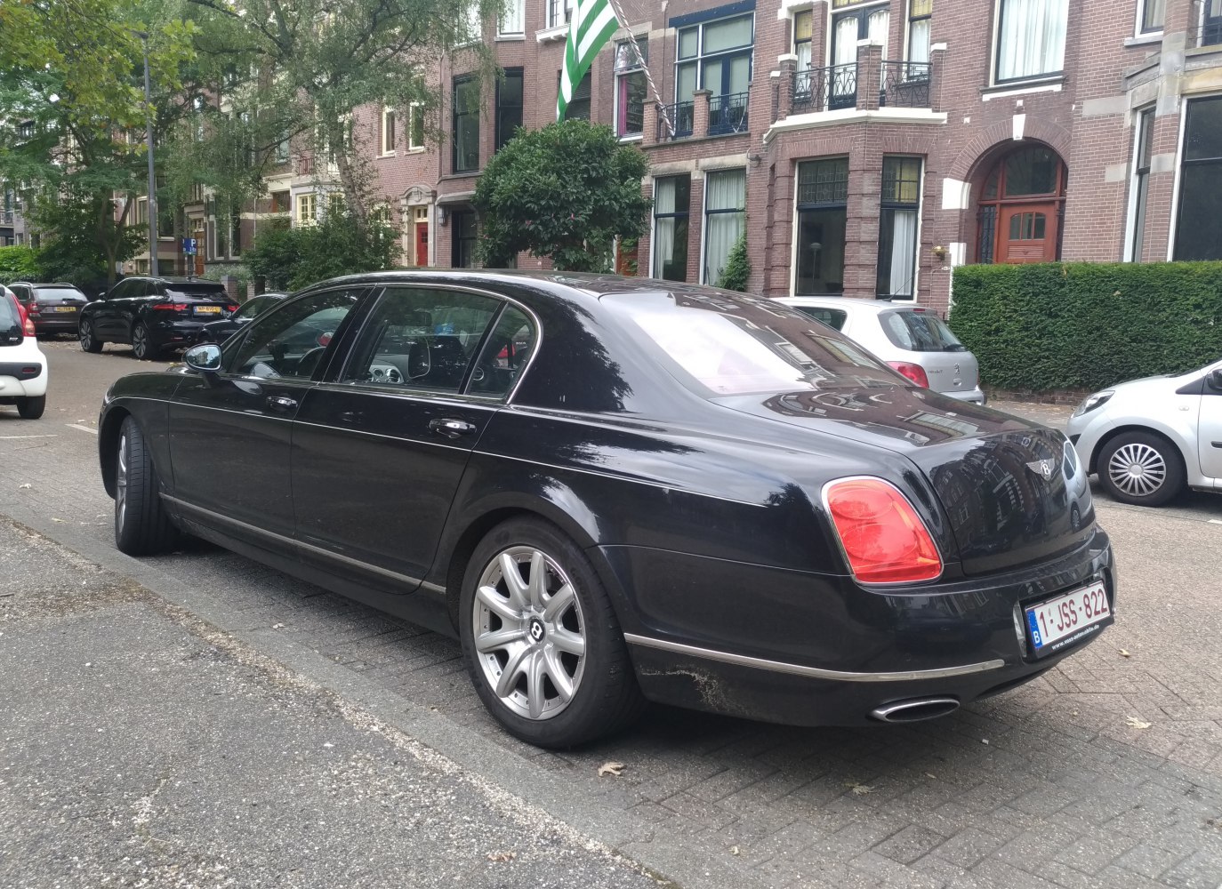 Luxury sedan rear view with dual exhaust and alloy wheels