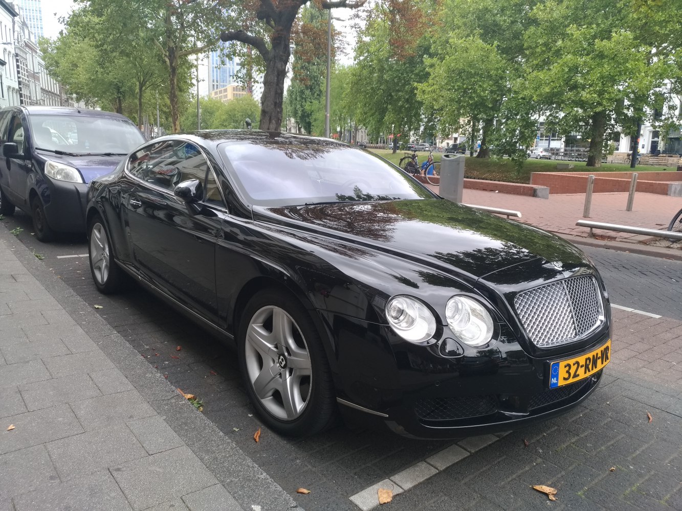 Luxury black coupé with mesh grille and quad round headlights