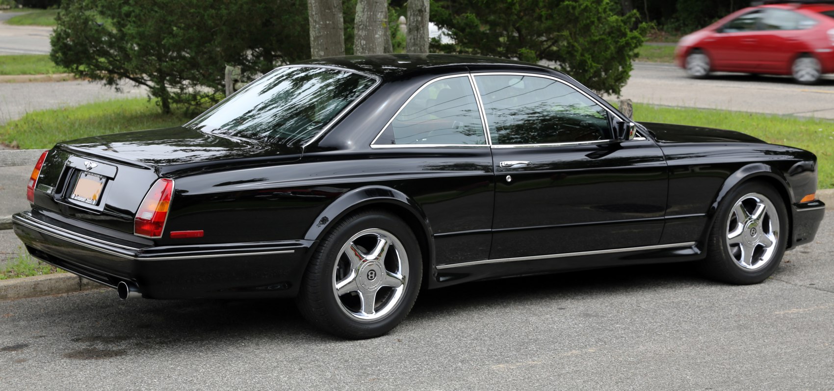 Black luxury coupe with chrome alloy wheels