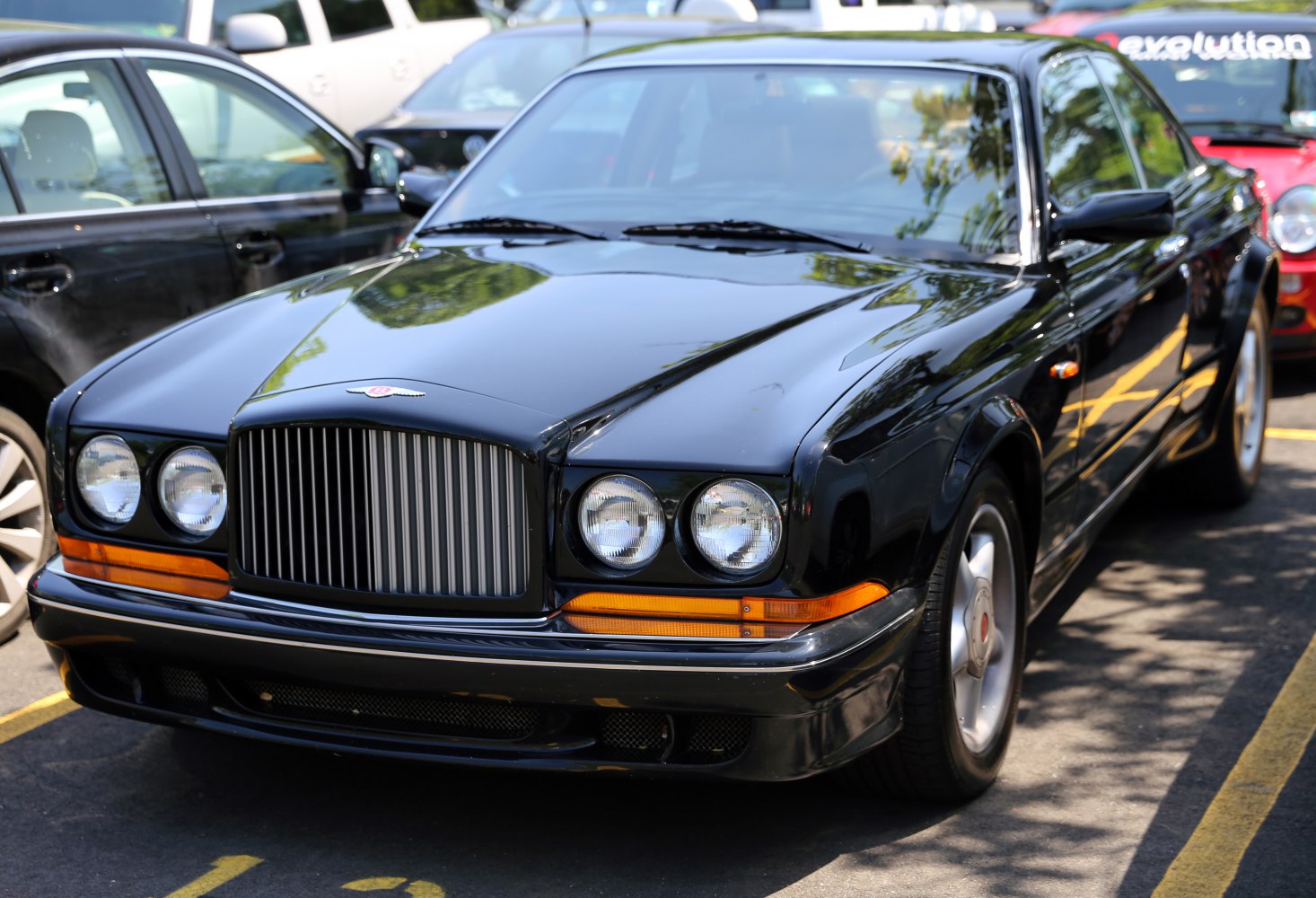 Front view of luxury sedan with vertical grille and round headlights