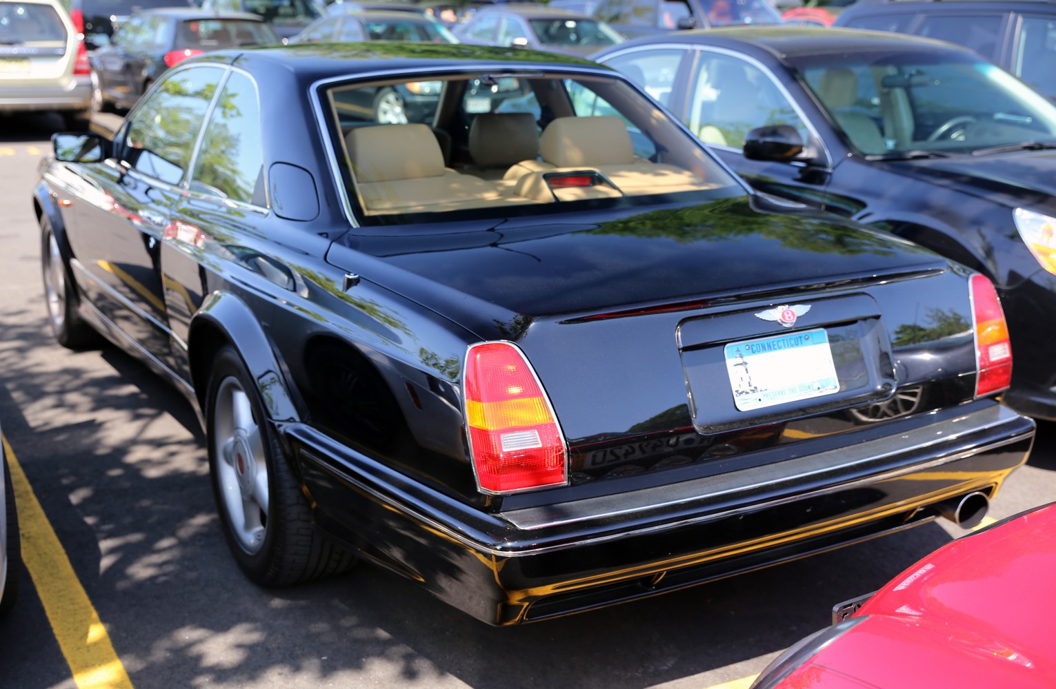 Rear view of black luxury coupe with distinctive tail lights and single exhaust