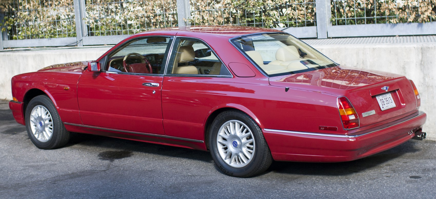 Rear three-quarter view of classic luxury coupe with alloy wheels and sunroof