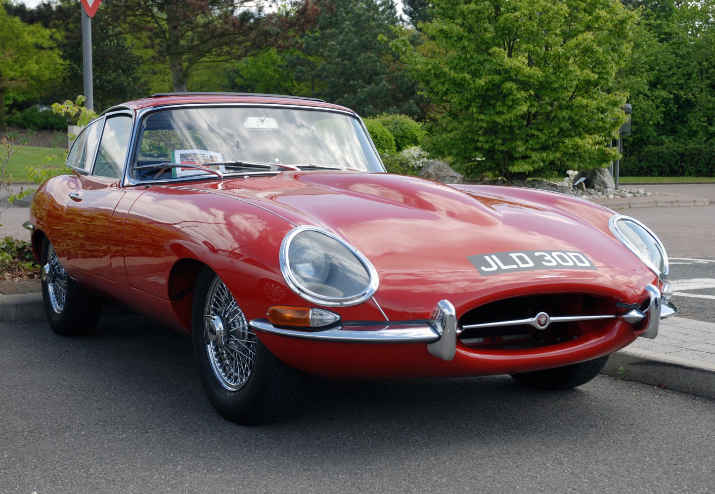 Sleek front end with oval headlights and chrome wire wheels