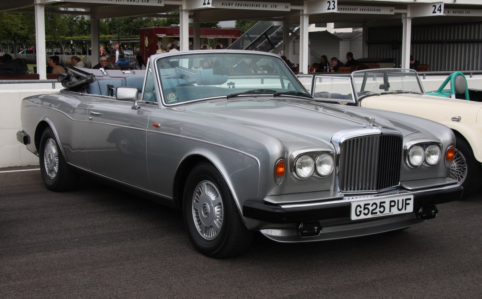 Classic convertible with large vertical grille and quad round headlights