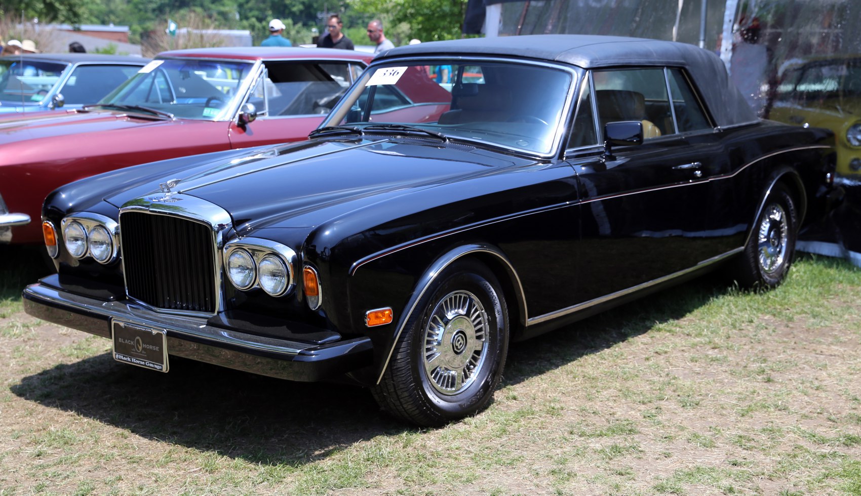 Black convertible with quad headlights and chrome grille