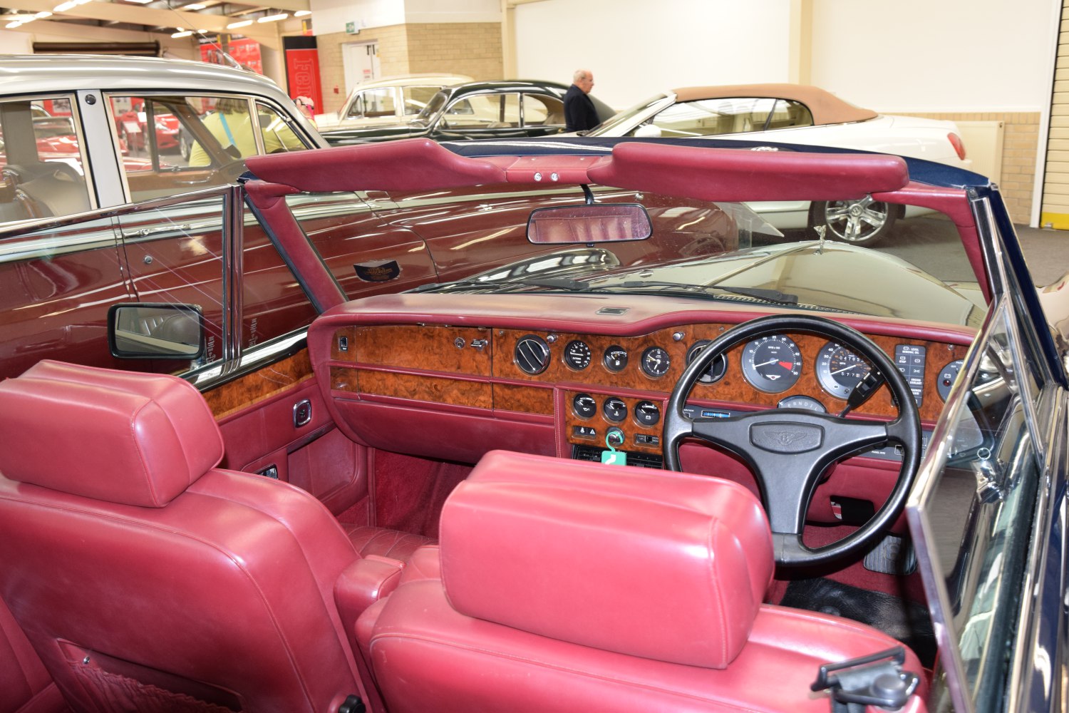 Wooden dashboard and red leather seats in classic convertible interior