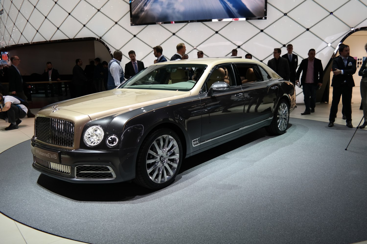 Two-tone luxury sedan with chrome grille and distinctive alloy wheels