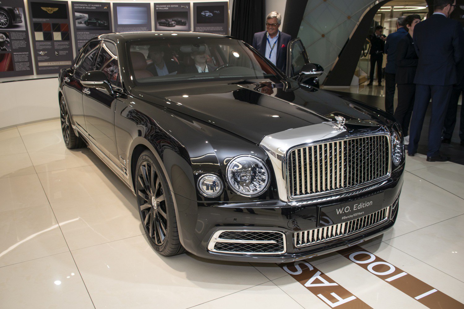 Prominent front grille and round headlights of a luxury sedan