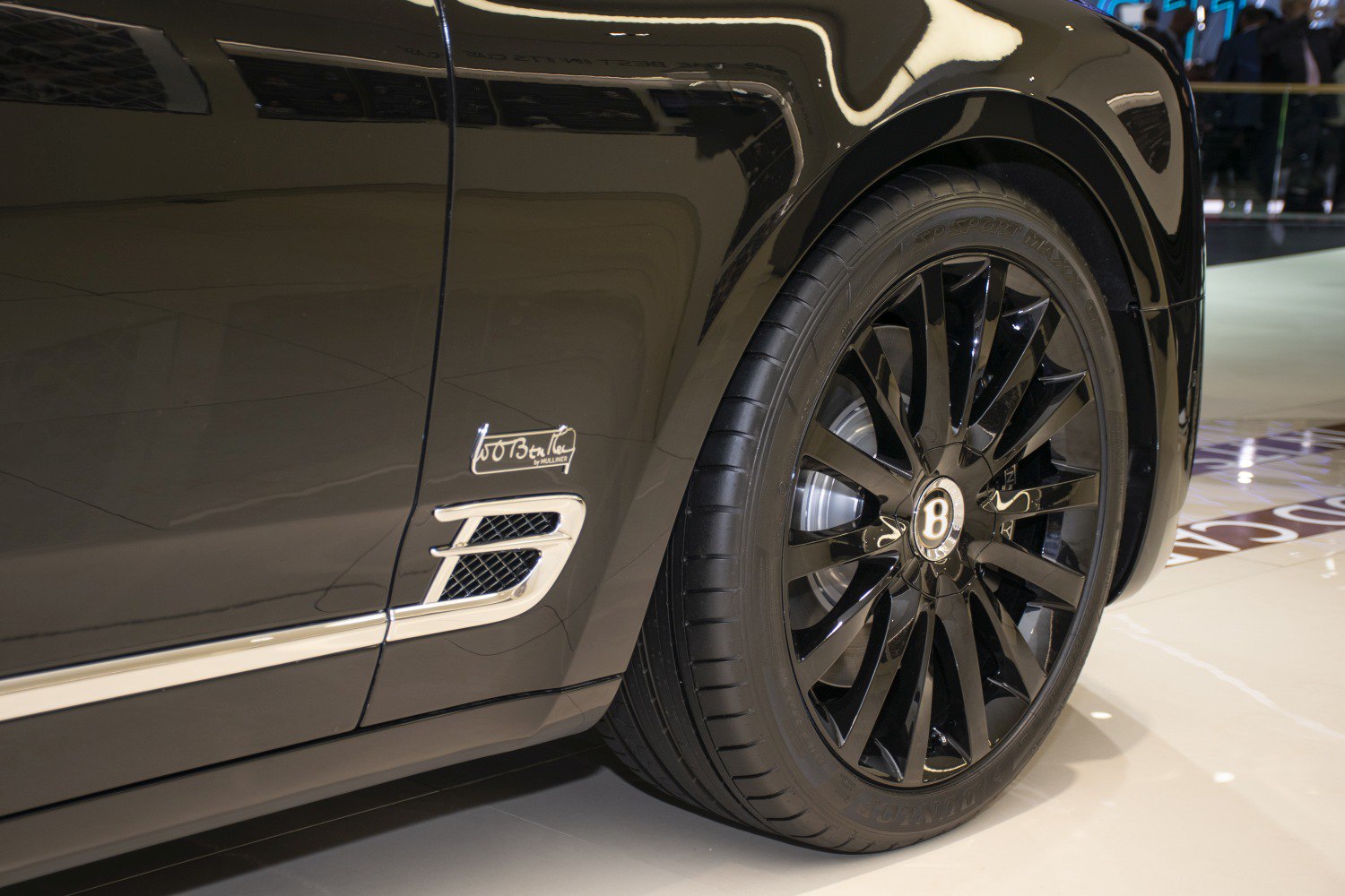 Side air vent with Mulliner badge and black multi-spoke wheel