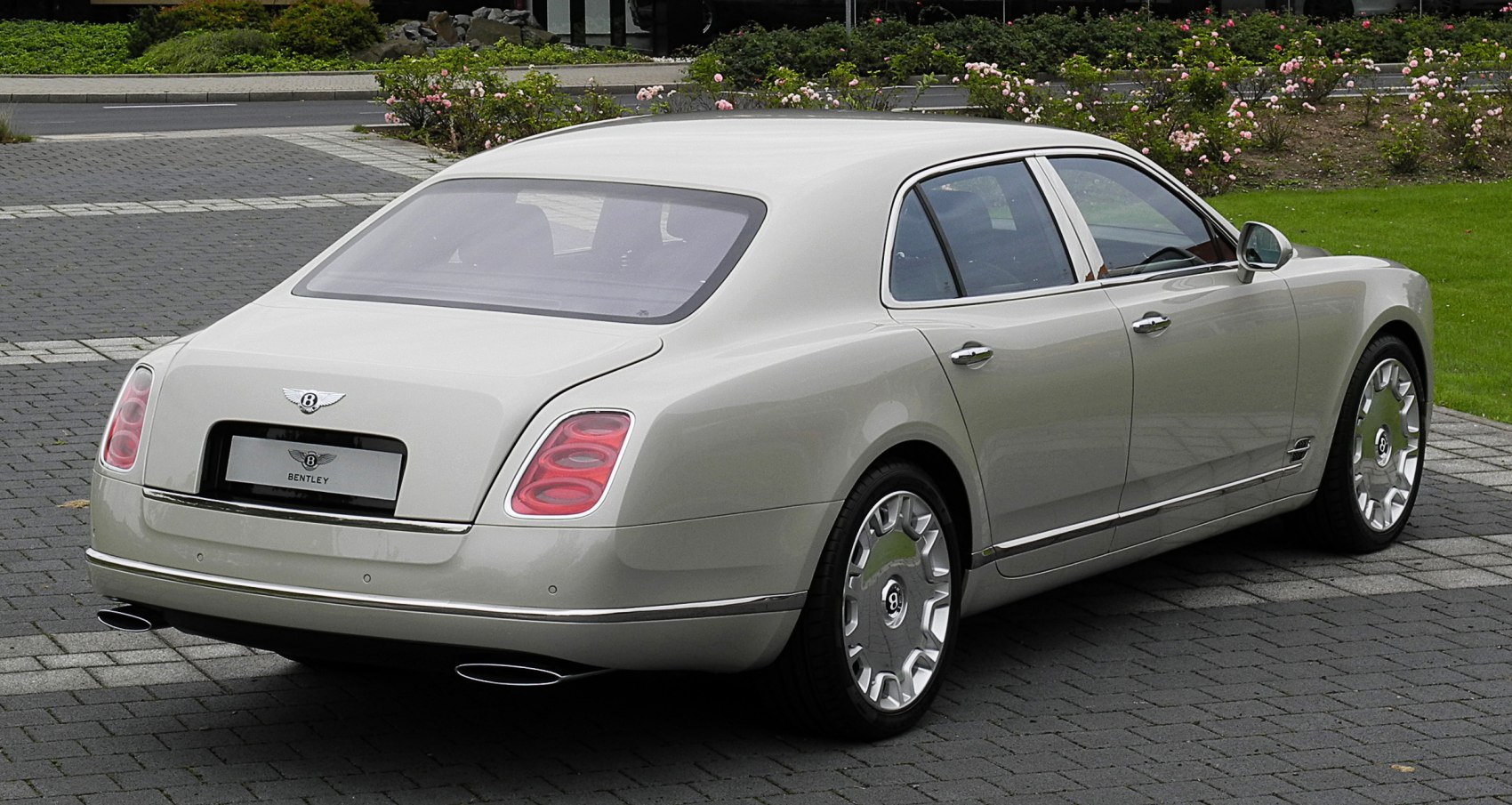 Luxury sedan rear and side view with oval tail lights and chrome trim