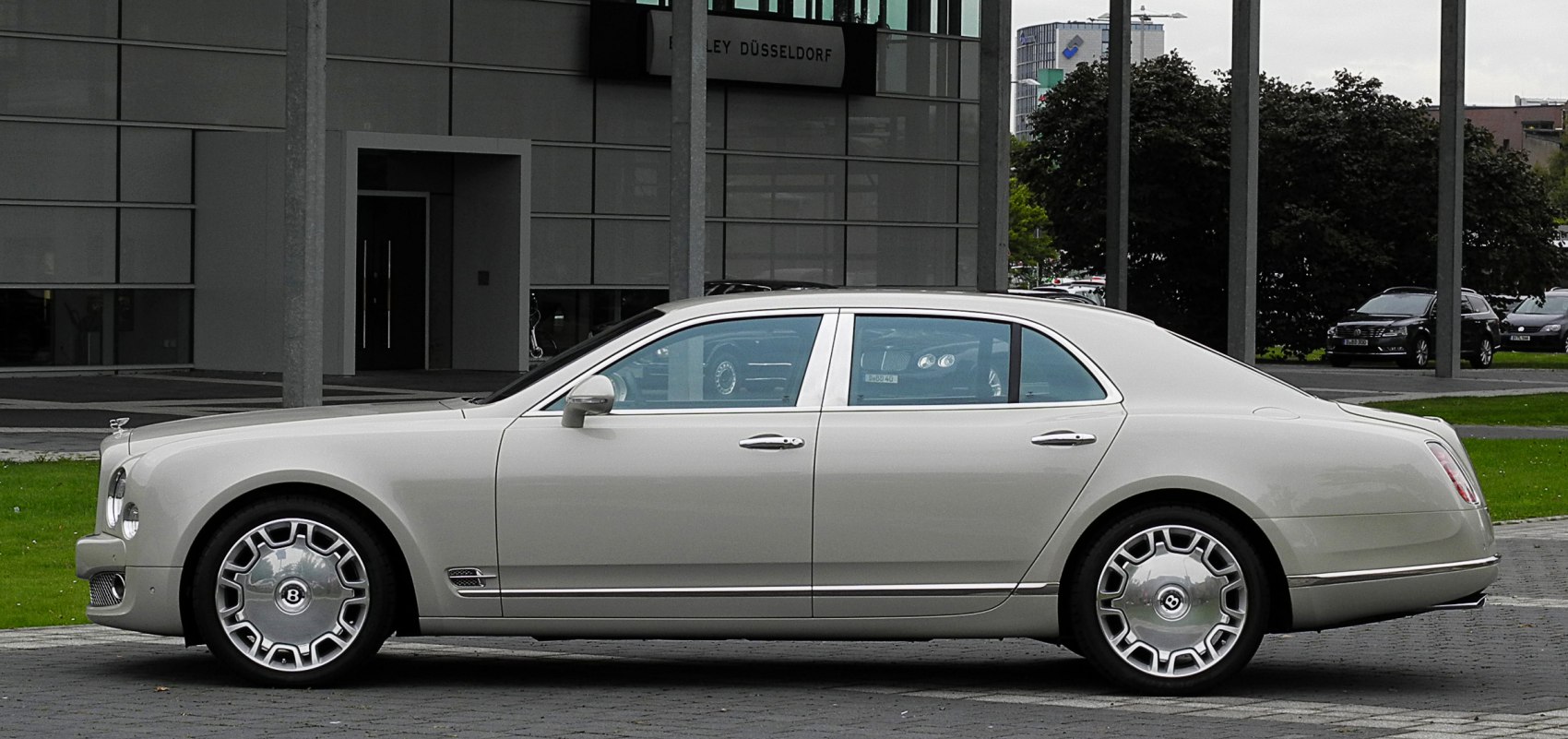 Side profile of a luxury sedan with distinctive alloy wheels and chrome accents.