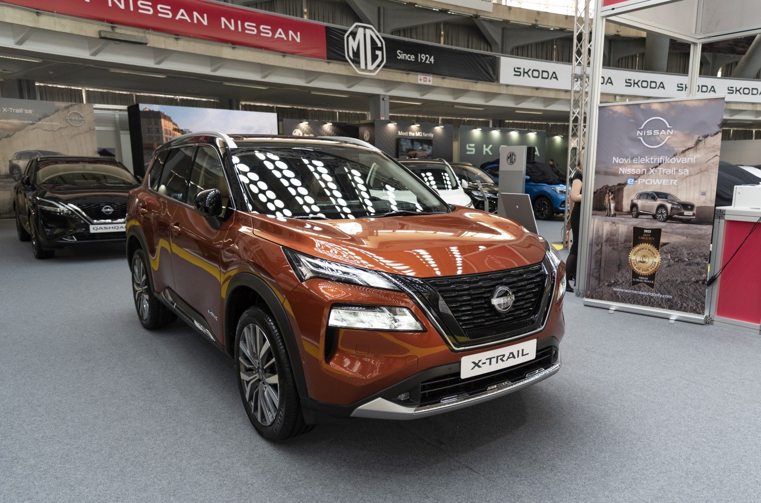 Sharp LED headlights and bold grille design of an SUV's front view at an auto show